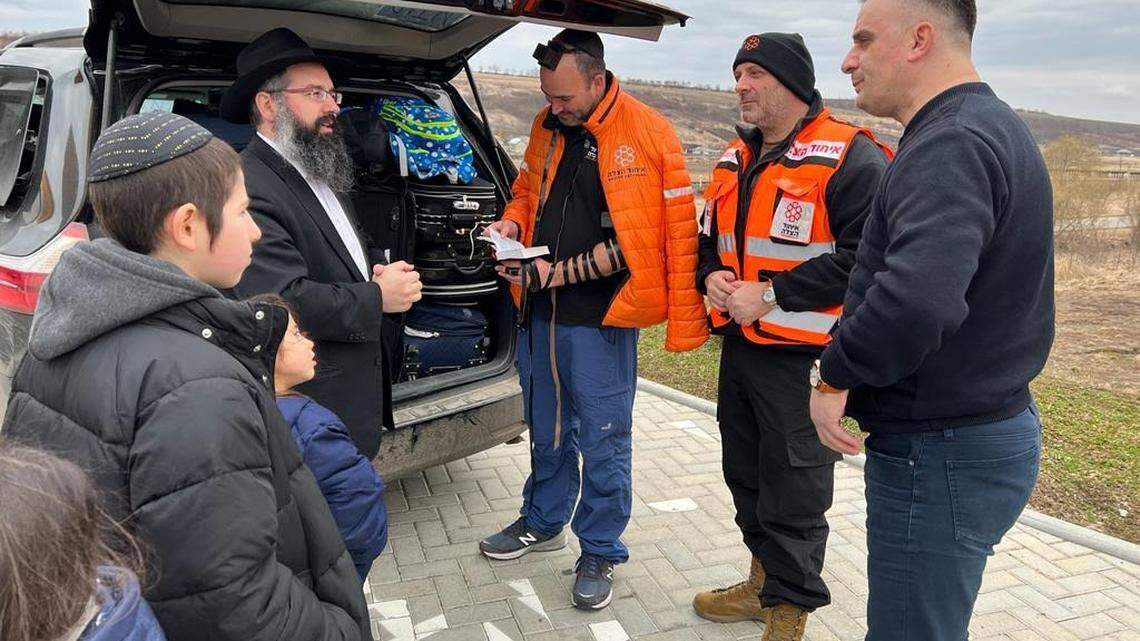 Dr. Zev Neuwirth, second from right, talks with refugees from Ukraine.