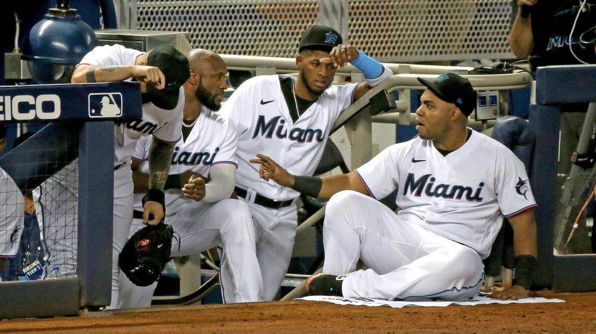 Miami Marlins Jesus Aguilar (24) talks with teammates in the dugout as they play the Toronto Blue Jays at loandepot park in Miami, Florida, June 22, 2021.