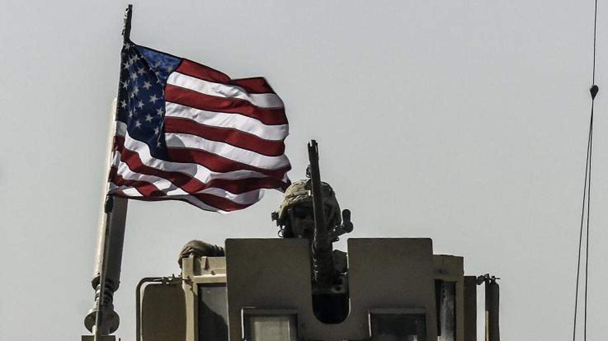 A U.S. military convoy drives on a highway from Kobane to Ain Issa, Syria.