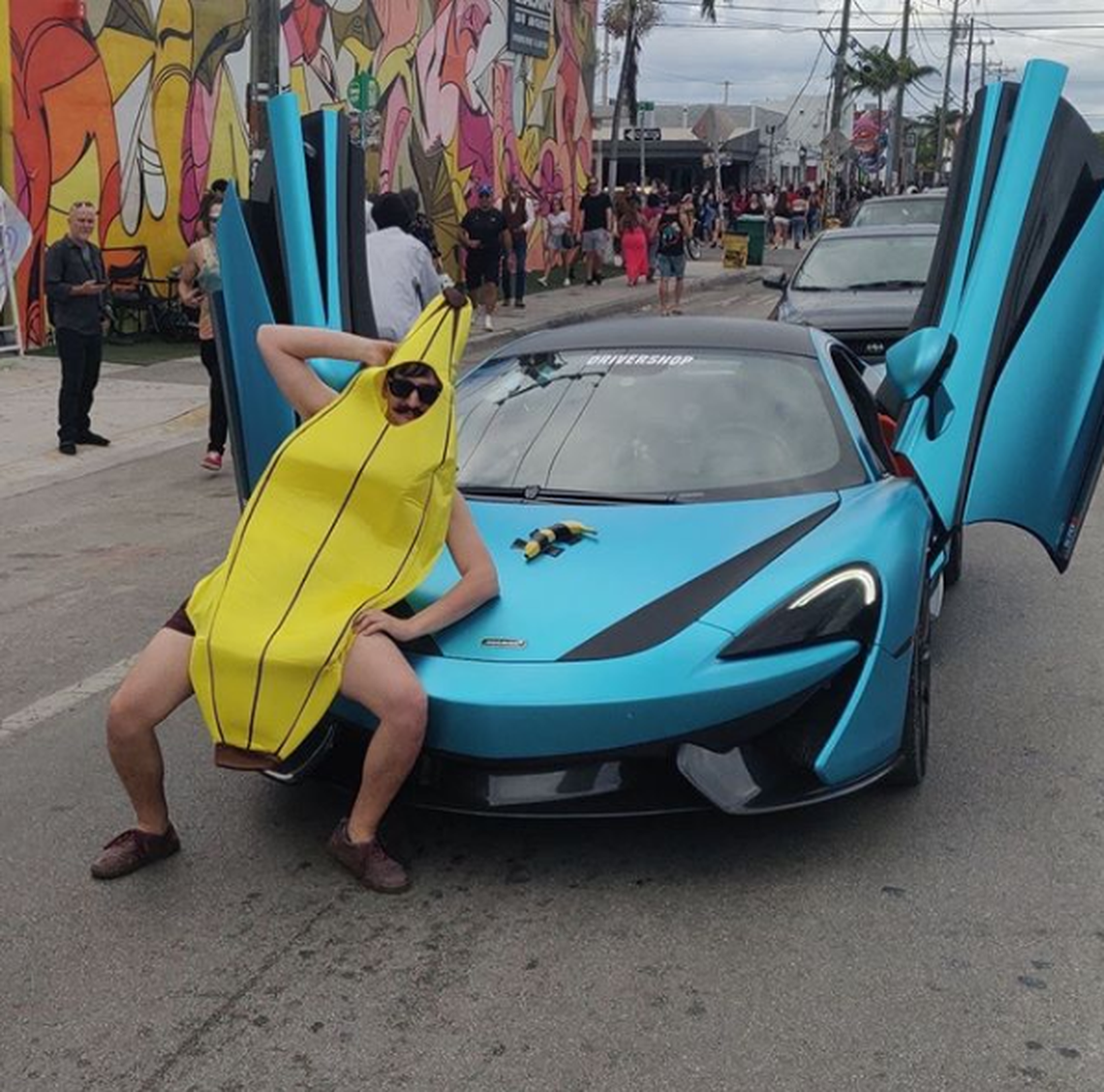 The Banana Man poses with a sports car during his visit to Wynwood during Art Basel 2019.