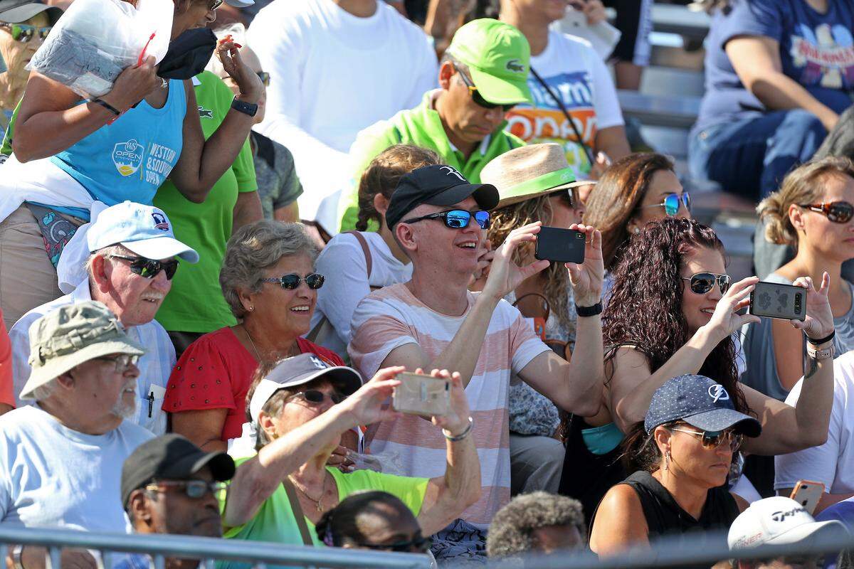 Tennis fans watch Serena Williams of the United States practicing during the fourth day of the Miami Open tennis tournament on Thursday, March 21, 2019, at Hard Rock Stadium in Miami Gardens.