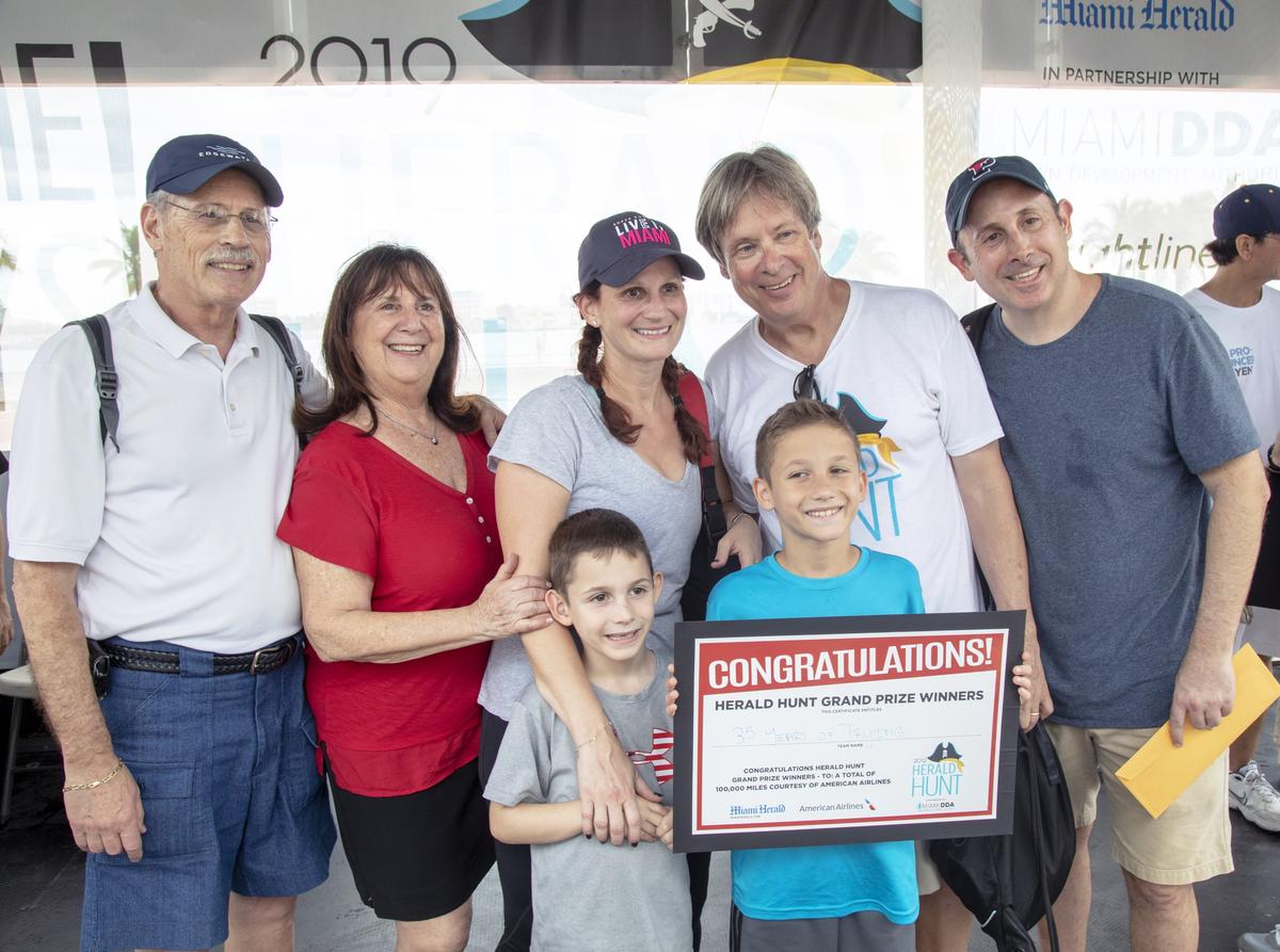 The Weisblums — Bob, Roslyn, Jacquie, Scott, Jake and Dylan&nbsp;— take a photo with host Dave Barry after winning the 2019 Herald Hunt at Bayfront Park.