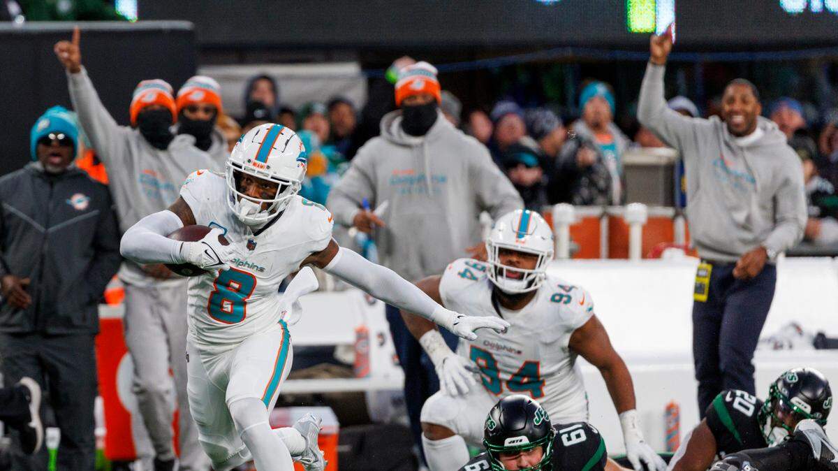 Miami Dolphins safety Jevon Holland (8) runs after intercepting a pass during second quarter of an NFL football game against the New York Jets at MetLife Stadium on Friday, Nov. 24, 2023 in East Rutherford, New Jersey.