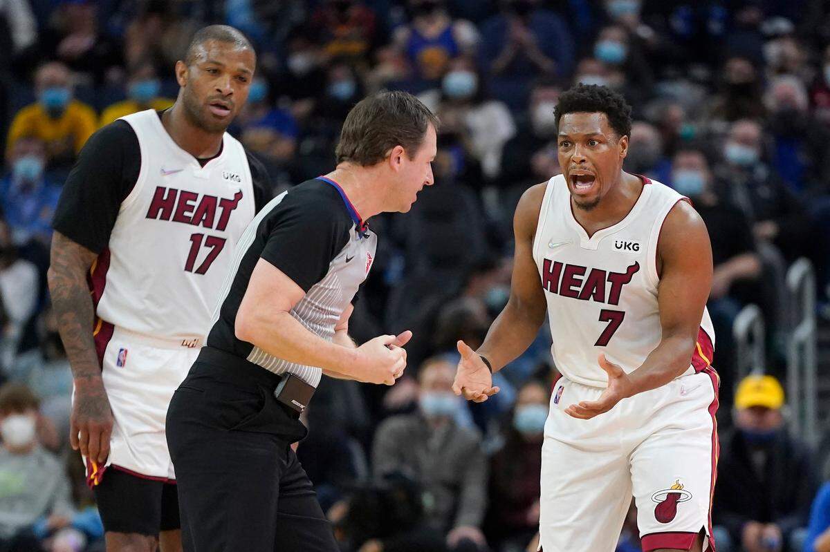 Miami Heat guard Kyle Lowry (7) and forward P.J. Tucker (17) react after a call toward referee Scott Twardoski during the first half of an NBA basketball game between the Golden State Warriors and the Heat in San Francisco, Monday, Jan. 3, 2022. (AP Photo/Jeff Chiu)