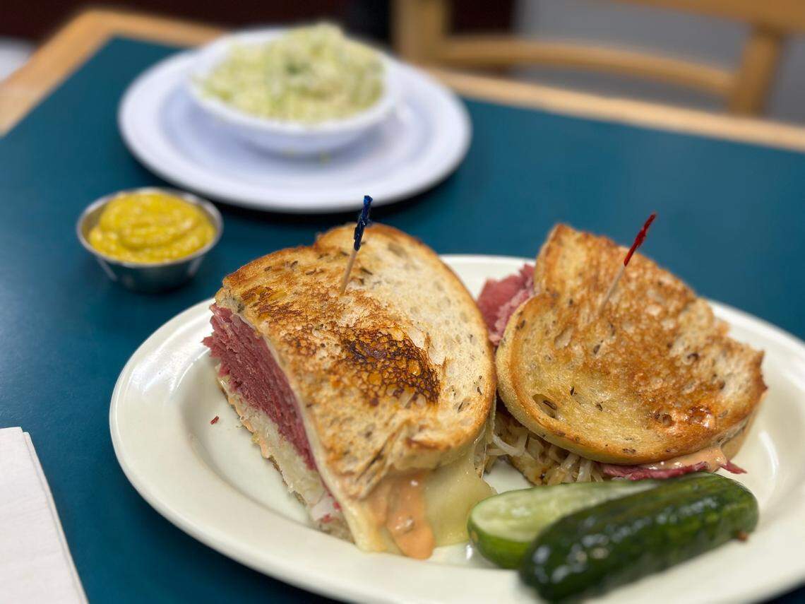 A Reuben sandwich piled with a side of cole slaw and sliced pickle, of course, at Lots of Lox in Palmetto Bay, South Miami-Dade, on April 24, 2024.