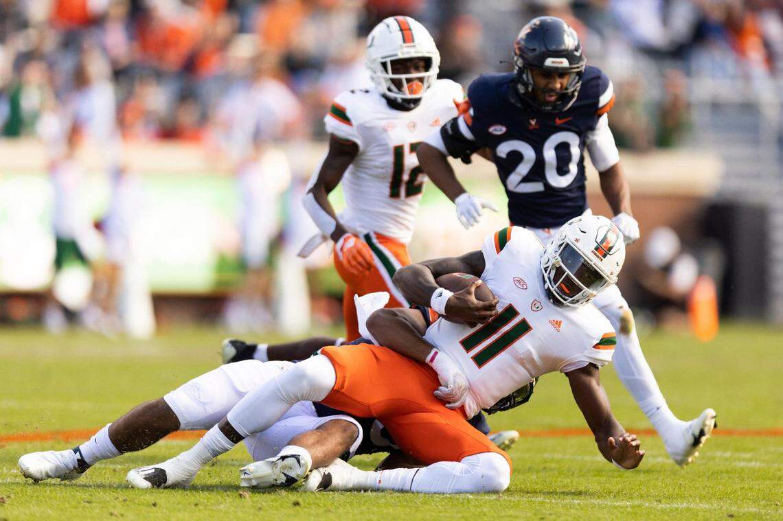 Miami quarterback Jacurri Brown is tackled during an NCAA college football game against Virginia in Charlottesville, Va., Saturday, Oct. 29, 2022. (Mike Kropf/The Daily Progress via AP)
