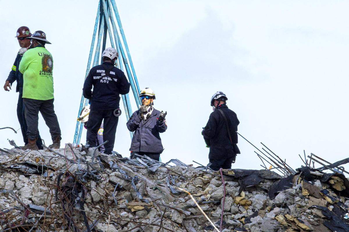 Florida Urban Search and Rescue teams probe for life through the rubble of the partially collapsed Champlain Towers South on the fourth day of recovery efforts, in the Surfside community of Miami Beach on Sunday, June 27, 2021.