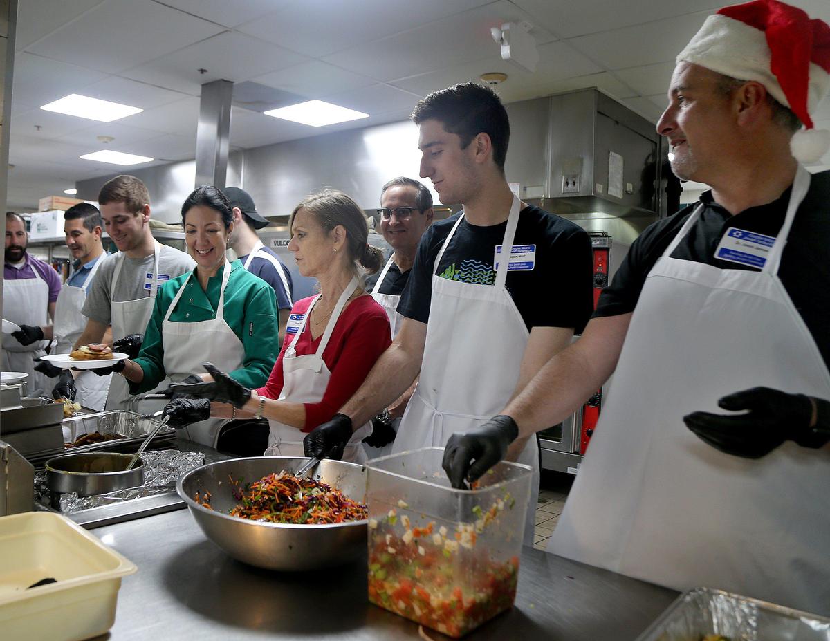 Miami city commissioners on Thursday passed an ordinance restricting when and where individuals and organizations can feed people experiencing homelessness. Here, volunteers serve Christmas meals at the Salvation Army shelter last Christmas.