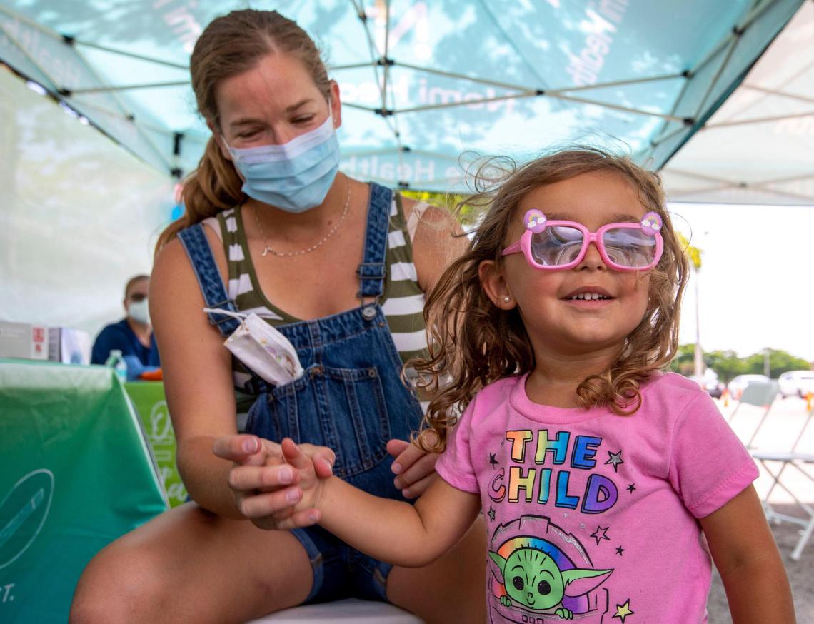 Miami resident Julie Budejen, 35, watches as her daughter Zoey, 3, reacts after a healthcare worker administered a Pfizer COVID-19 vaccine at the Nomi Health Mobile Health Unit at Tropical Park in Miami on Saturday, June 25, 2022. On Saturday, Miami-Dade County began offering free COVID-19 vaccinations to children under age 5, the last group to receive authorization for the vaccine, at eight sites around the county. The county will continue offering the vaccines Sunday through Wednesday.