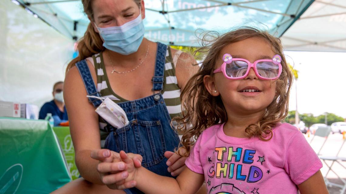 Julie Budejen, 35, watches as her daughter Zoey, 3, reacts after a healthcare worker administered a Pfizer COVID-19 vaccine at the Nomi Health Mobile Health Unit inside Tropical Park in Miami on Saturday, June 25, 2022. Saturday was the first day that children under 5 could receive a free COVID vaccination at one of eight sites throughout Miami-Dade County. The shots will be administered on Sunday and throughout the week.