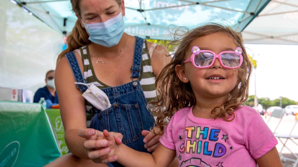 Julie Budejen, 35, watches as her daughter Zoey, 3, reacts after a healthcare worker administered a Pfizer COVID-19 vaccine at the Nomi Health Mobile Health Unit inside Tropical Park in Miami on Saturday, June 25, 2022. Saturday was the first day that children under 5 could receive a free COVID vaccination at one of eight sites throughout Miami-Dade County. The shots will be administered on Sunday and throughout the week.