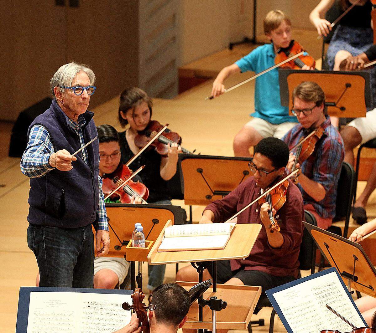 Michael Tilson Thomas, Co-Founder and Artistic Director of the New World Symphony, directs students during a rehearsal. The symphony is participating in a new arts program in Miami Beach schools.