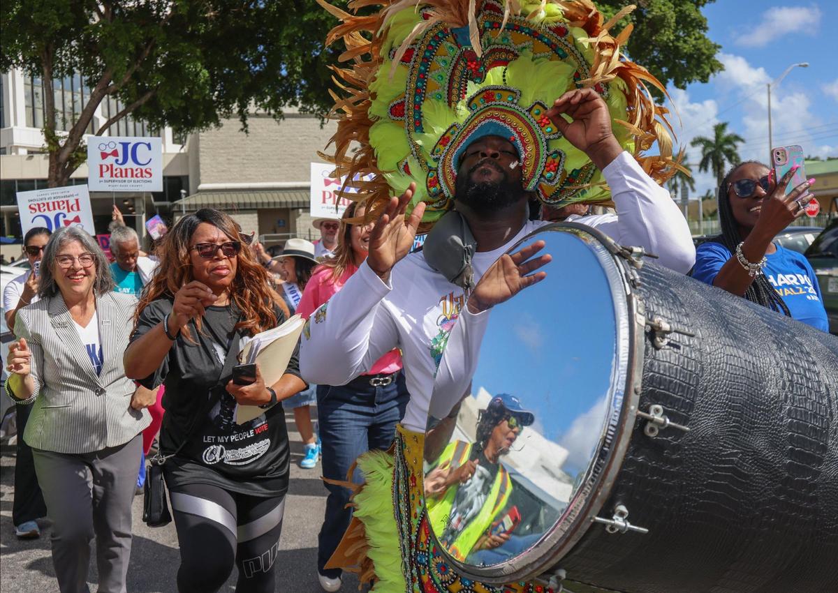 Democratic candidates, Mayor Daniella Levine Cava, left, and unincorporated Miami-Dade voters dance to the sounds of the Bahamian Junkanoo band during a festive visit to the polls at the Joseph Caleb Center during the “Souls to the Polls” event on the last day of early voting on Sunday, Nov. 3, 2024 in Miami, Florida.