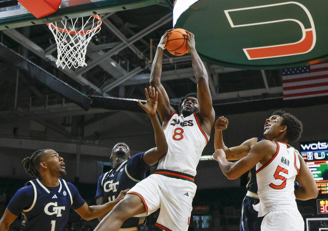 Miami Hurricanes center Ernest Udeh Jr. (8) grabs a rebound during the second half of an NCAA basketball game against the Georgia Tech Yellow Jackets at the Watsco Center on the University of Miami Campus on Saturday, January 10, 2026 in Coral Gables, Florida.