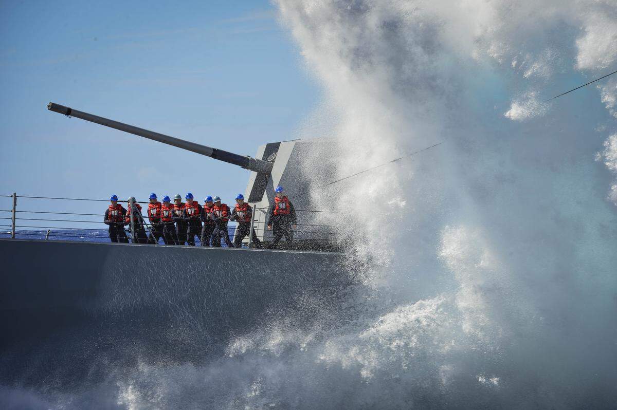 Sailors assigned to the Arleigh Burke-class guided-missile destroyer USS Sampson handle lines during a fueling-at-sea in the Pacific Ocean in October 2017.