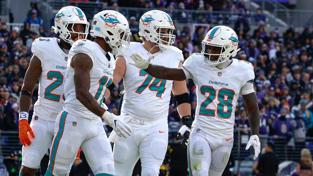 Miami Dolphins wide receiver Cedrick Wilson Jr. (11) celebrates with teammates Jeff Wilson Jr. (23) Liam Eichenberg (74) and De’Von Achane (28) after scoring a touchdown during first half of an NFL football game against the Baltimore Ravens at M&T Bank Stadium in Baltimore, Maryland on Sunday, December 31, 2023.