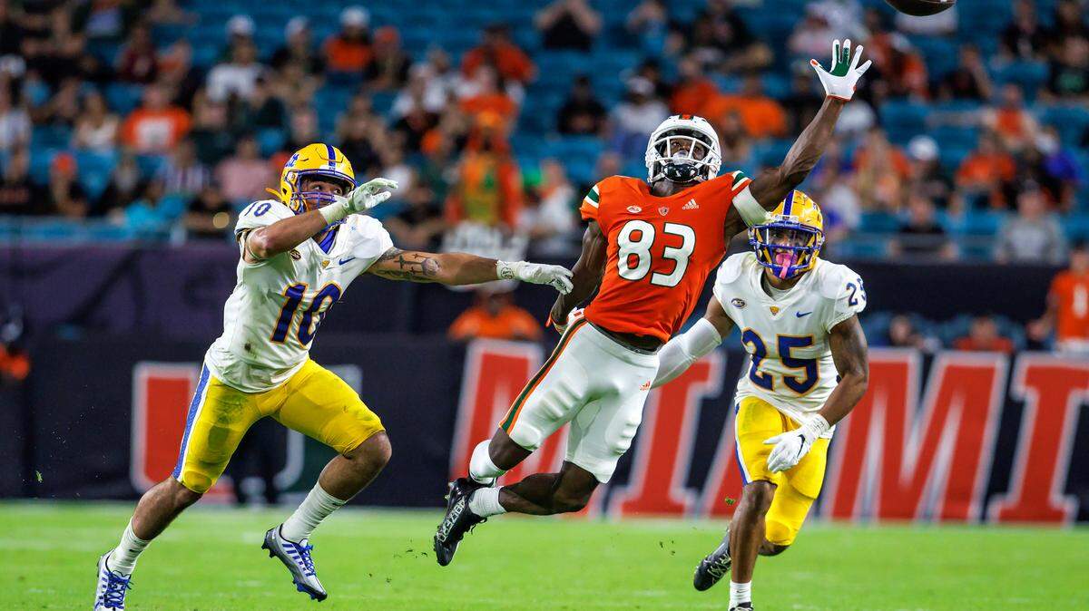 Pittsburgh Panthers linebacker Tylar Wiltz (10) and Panthers defensive back A.J. Woods (25) defend Miami Hurricanes wide receiver Michael Redding III (83) as is unable to reach an overthrows pass by Hurricanes quarterback Jake Garcia (13) during the second quarter of an ACC conference football game at Hard Rock Stadium on Saturday, November 26, 2022 in Miami Gardens, Florida.