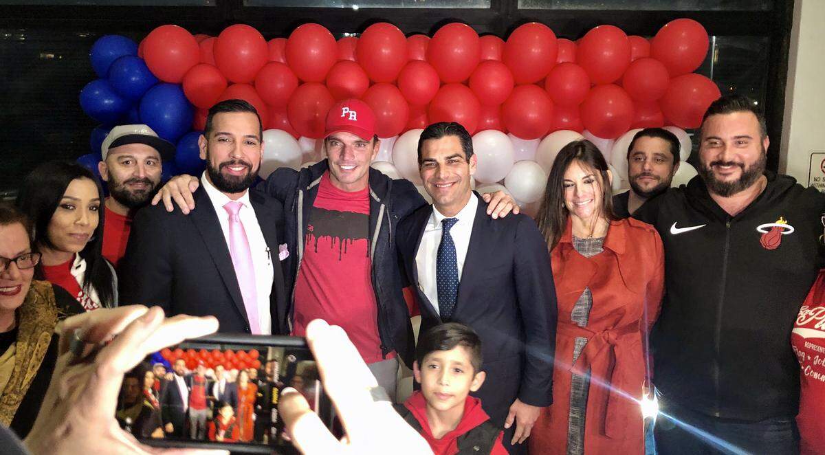Spanish television star Julián Gil wore his red Puerto Rico hat to Thursday’s Miami city commission meeting, when his restuarant, La Placita, was given the right to keep its three-story flag mural temporarily. Mayor Francis Suarez, right of Gil, called it a victory for Puerto Rico.