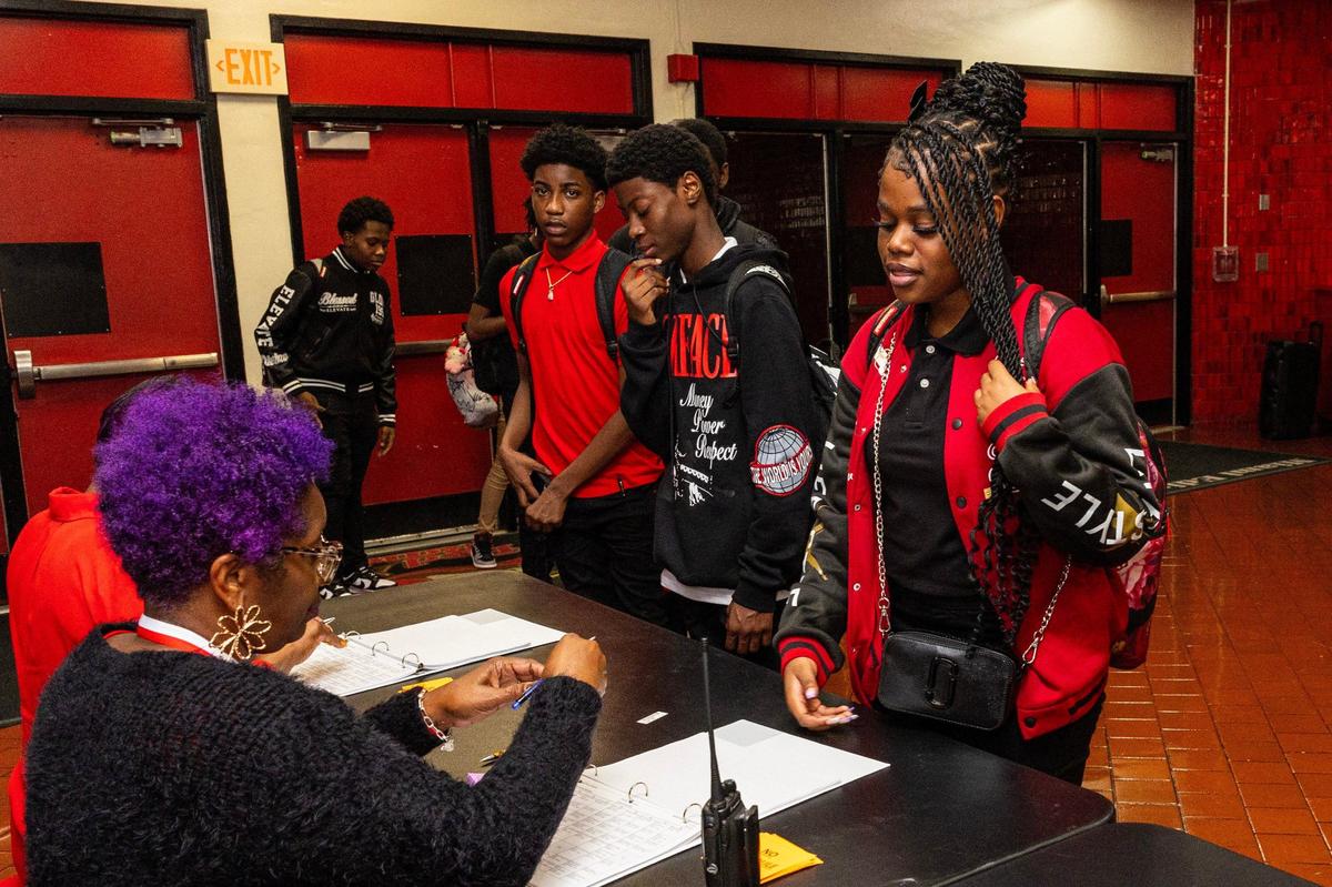 Students line up to sign in during the first day of school at Miami Edison High.