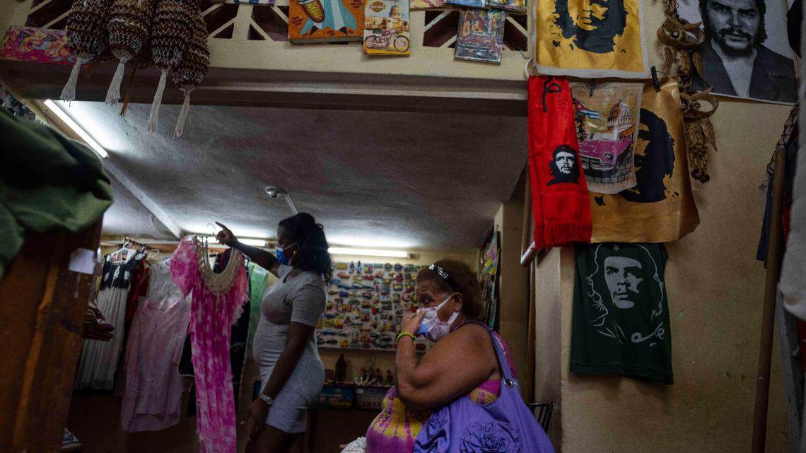 A woman waits to be shown a dress in a private clothing and craft store in Havana, Cuba, Thursday, Sept. 16, 2021. (AP Photo/Ramon Espinosa)