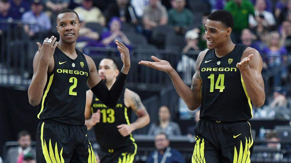 LAS VEGAS, NEVADA - MARCH 16: Louis King #2 and Kenny Wooten #14 of the Oregon Ducks celebrate on the court during the championship game of the Pac-12 basketball tournament against the Washington Huskies at T-Mobile Arena on March 16, 2019 in Las Vegas, Nevada. The Ducks defeated the Huskies 68-48. (Photo by Ethan Miller/Getty Images)