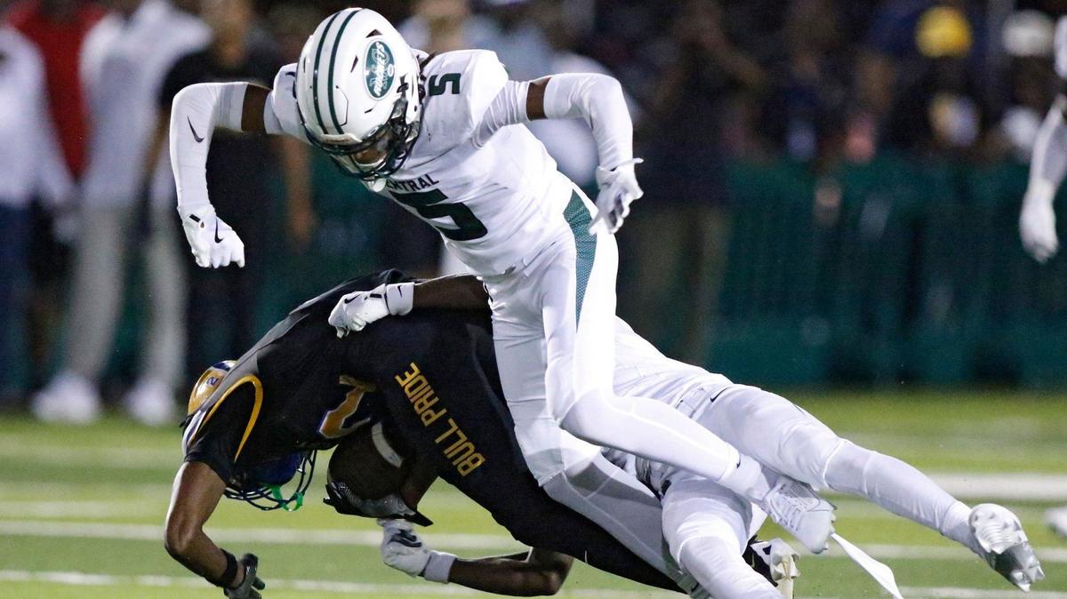Miami Central Rockets defenders take down Northwestern Bulls ball carrier Nicholas Lenneer during their football game on Friday, October 4, 2024 at Traz Powell Stadium in Miami.