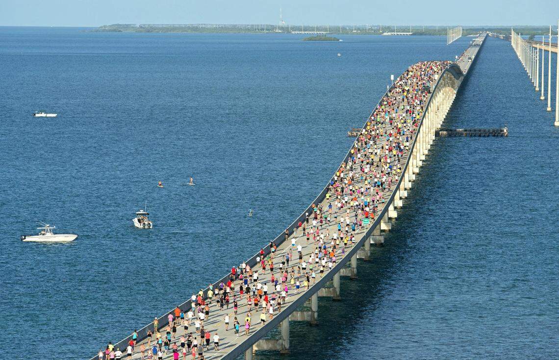 A portion of the field of 1,500 competitors run across the convergence of the Atlantic Ocean and Gulf of Mexico during the Seven Mile Bridge Run Saturday, April 18, 2015, near Marathon.