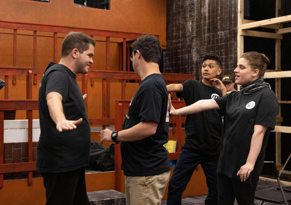 Ricardo Garcia, playing Buddy the Elf, left, Joseph Paz, playing Walter Hobbs, Lucas Lowery, playing Michael Hobbs, and Elizabeth Bales rehearse Act I during the Inclusion Theatre Project’s rehearsal for ‘Elf Jr.’ the musical on Monday, Nov. 28, 2022, at Area Stage Company in South Miami.
