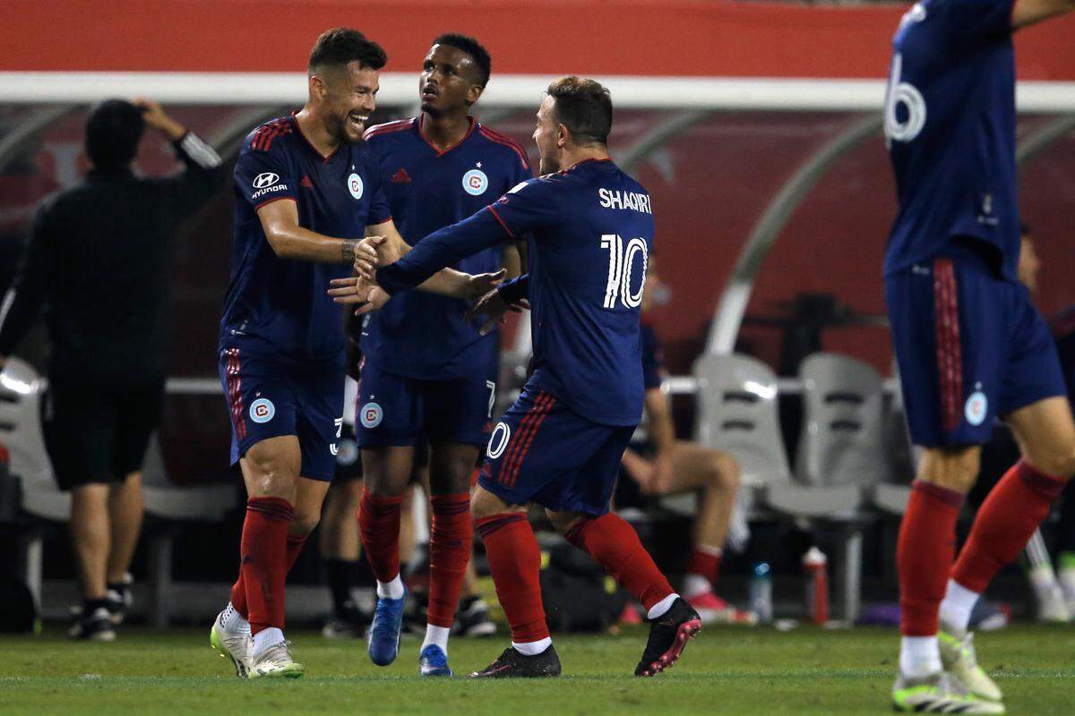 Oct 4, 2023; Chicago, Illinois, USA; Chicago Fire midfielder Xherdan Shaqiri (10) celebrates with midfielder Gaston Gimenez (30) after scoring a goal against Inter Miami CF during the second half at Soldier Field. Mandatory Credit: Jon Durr-USA TODAY Sports