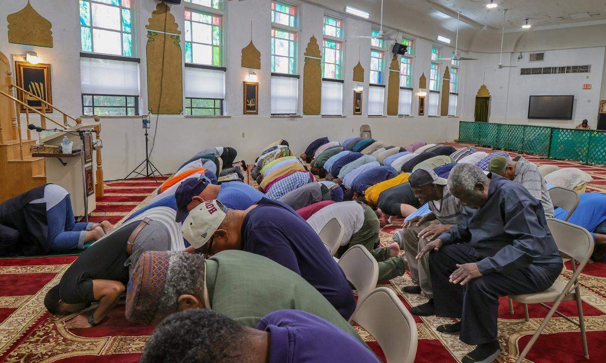 Many mosques open their doors during the holy month of Ramadan to non-Muslims to welcome them to traditional dinners. Here men pray during the Jumu’Ah prayer service lead by Imam Nasir Ahmadn at Masjid Al-Ansar in 2024.