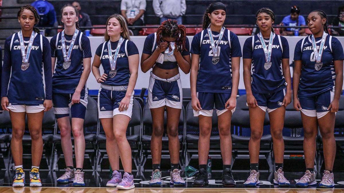 Calvary Christian Academy players react after receiving their runners-up medals after being defeated by Lake Highland Prep in the Class 4A girls basketball state championship at the RP Funding Center in Lakeland on Saturday, February 26, 2022.