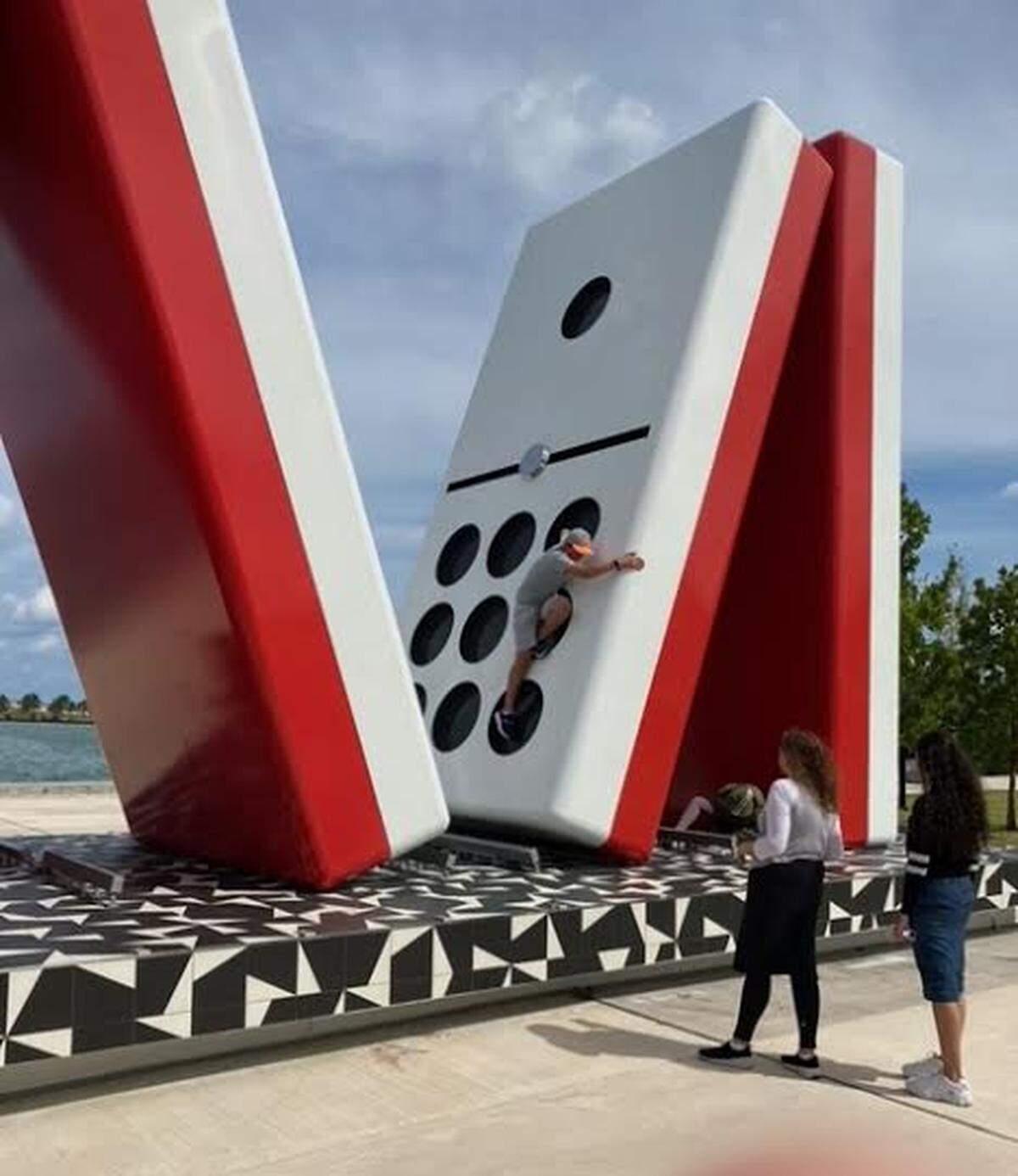 Jose Milton’s family paid for a redesign that replaced lots of green grass with pavement and made an outsized domino sculpture the centerpiece of the park.