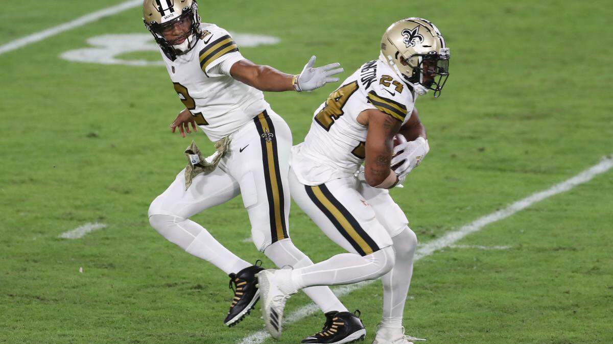 New Orleans Saints quarterback Jameis Winston (2) hands off to running back Dwayne Washington (24) during the second half of an NFL football game against the Tampa Bay Buccaneers Sunday, Nov. 8, 2020, in Tampa, Fla.