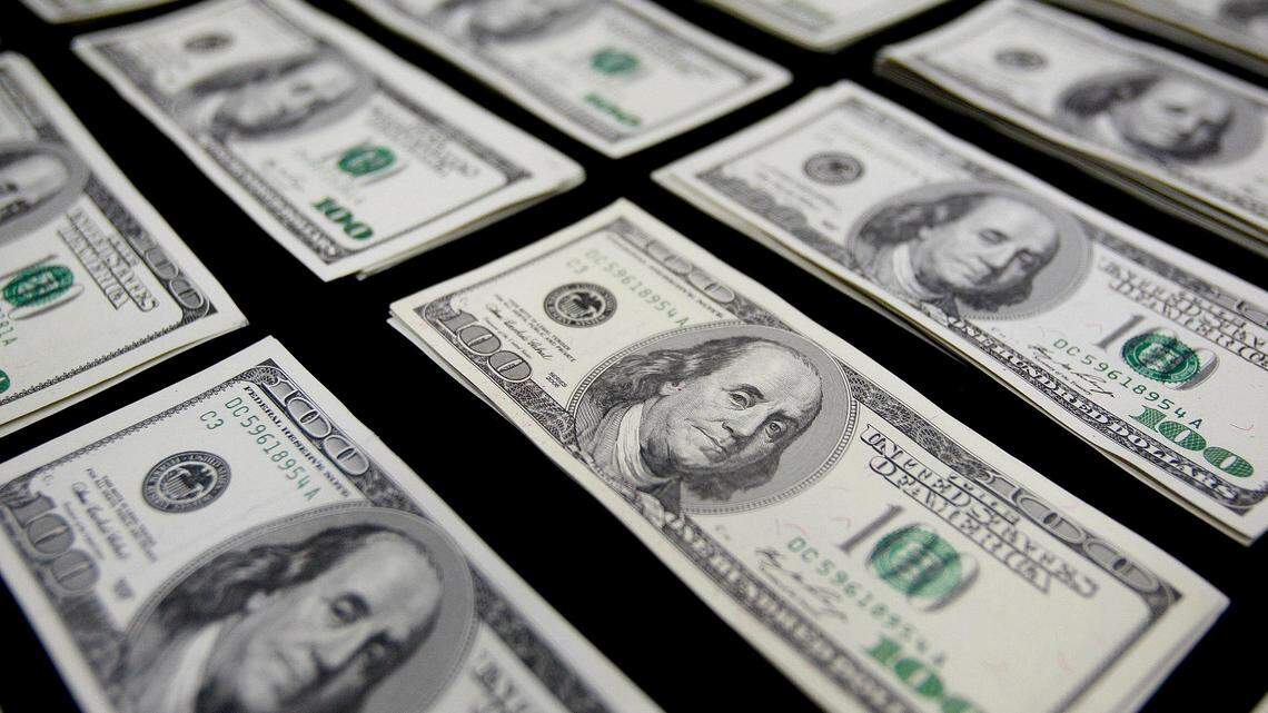Alleged counterfeit $100 notes sit on display during a police news conference in Lima, Peru, on Aug. 17, 2012. A printer and $30,000 in fake cash were found in a couple’s Florida hotel room, feds say.