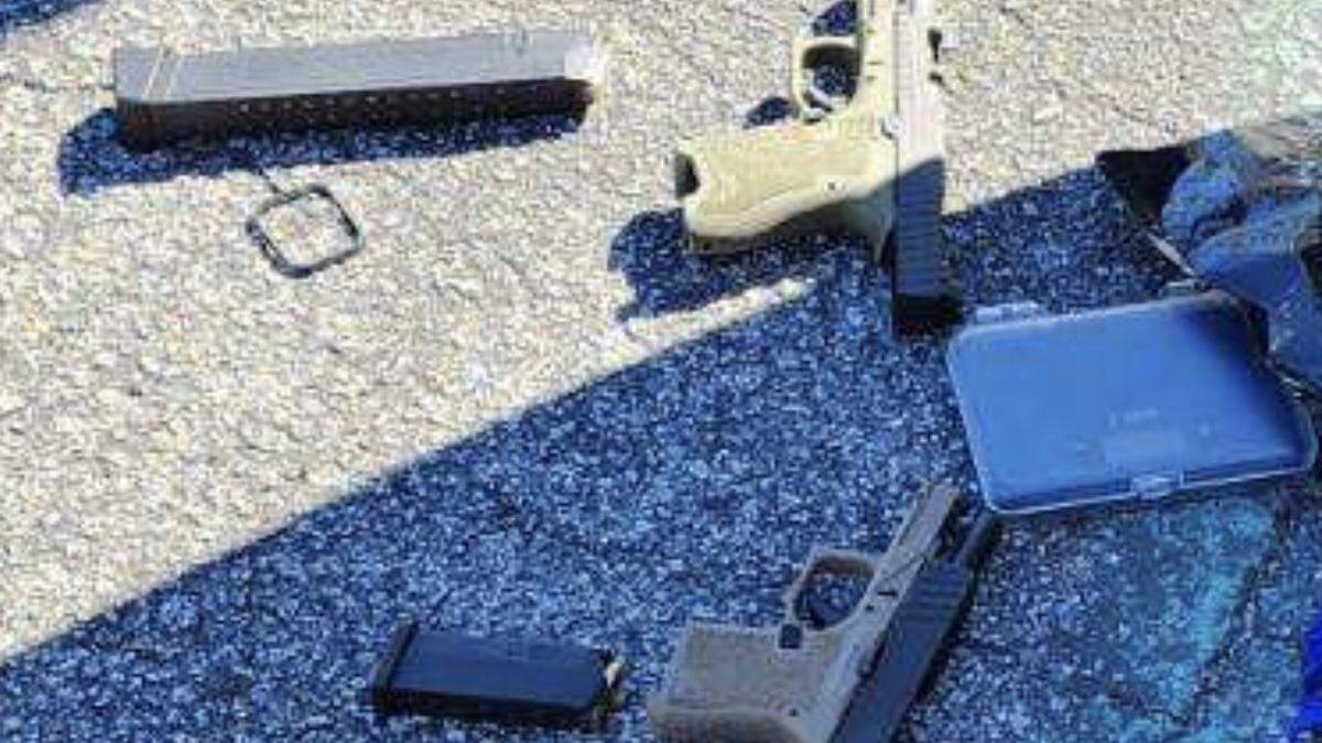 Two handguns and magazines are displayed that Broward Sheriff’s Office deputies say they found inside a car parked on the campus of Deerfield Beach High School Monday, Jan. 29, 2024.