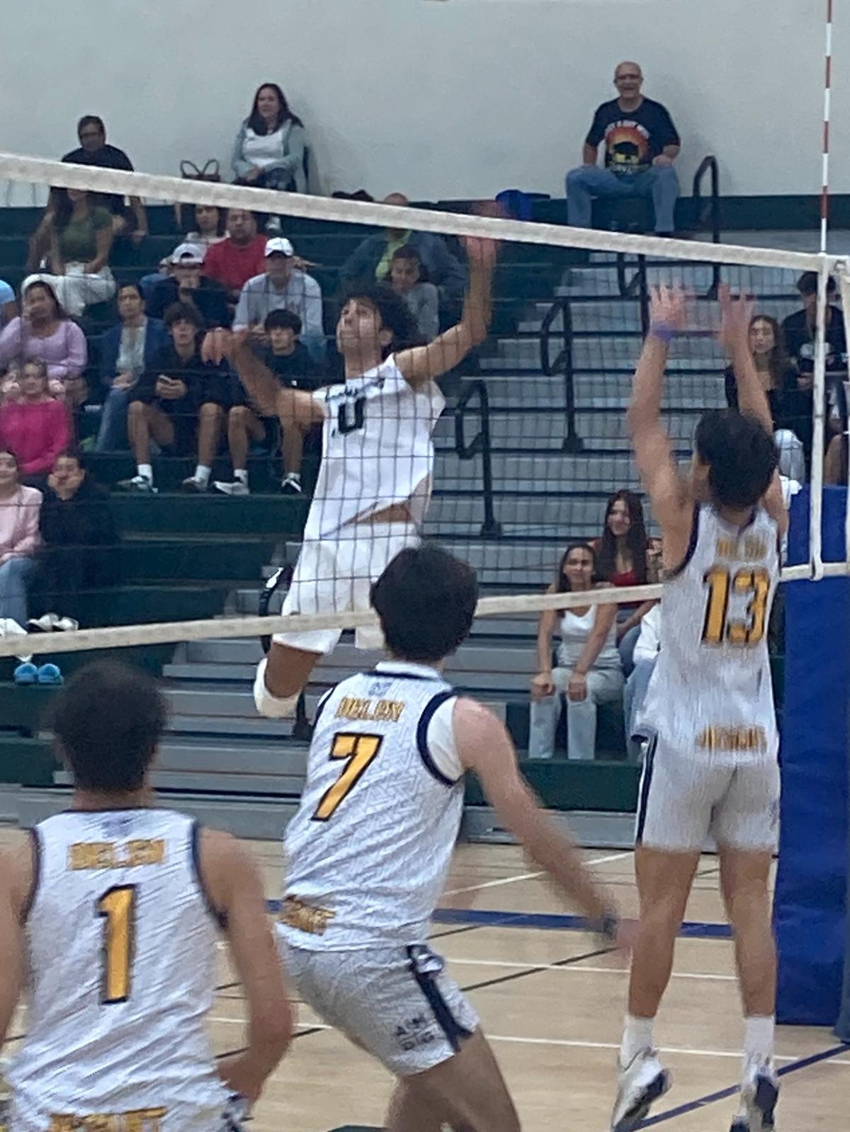 Reagan’s Yeison Gonzalez jumps up to deliver a spike during Friday’s Region 4-2A semifinal match against Belen Jesuit.
