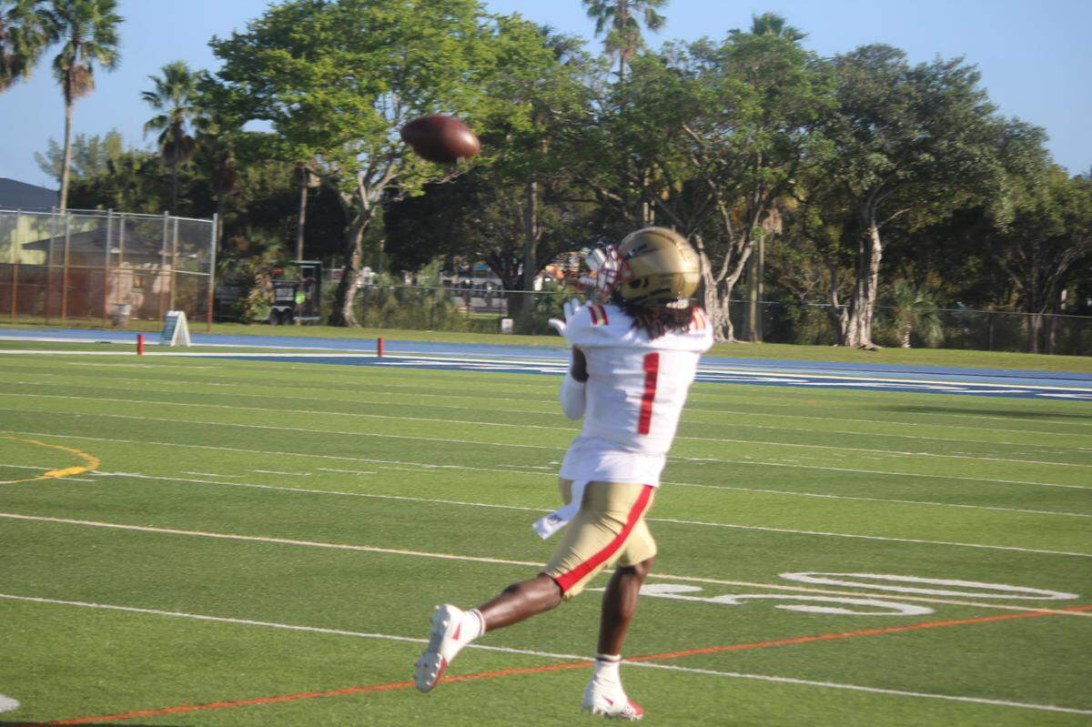 Monsignor Pace WR Willie Anderson reels in a pass that turned into an 80-yard touchdown on the game’s first play on Friday at Tropical Park.