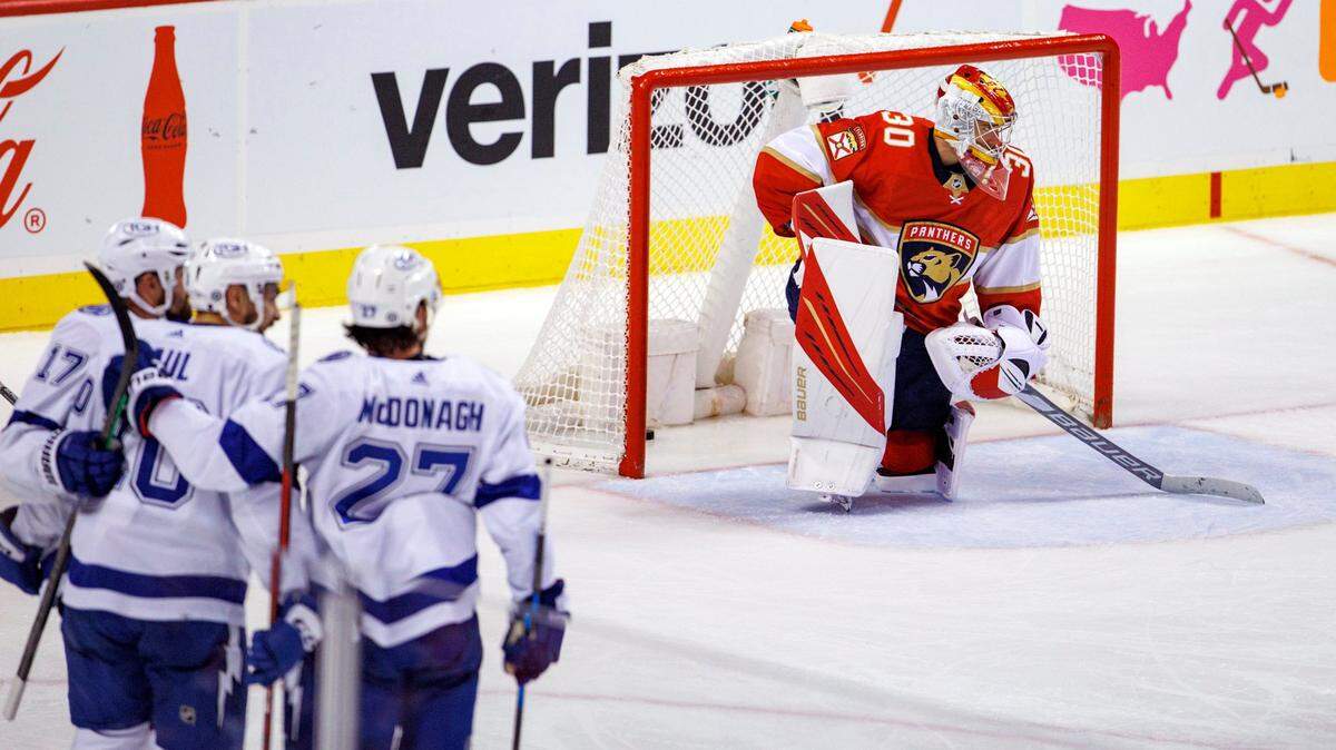 Florida Panthers goaltender Spencer Knight (30) looks on as Tampa Bay Lightning left wing Nicholas Paul (20) is congratulated by teammates after scoring a goal during the second period of an NHL game at the FLA Live Arena on Sunday, April 24, 2022 in Sunrise, Fl.