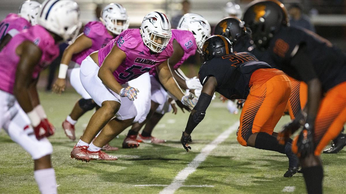 Chaminade-Madonna College Preparatory offensive lineman Willie Moise (52) braces for a block against Booker T. Washington Senior High School defensive lineman Travaris Lark (36) during a game last October. Moise has committed to UM as a defensive lineman.