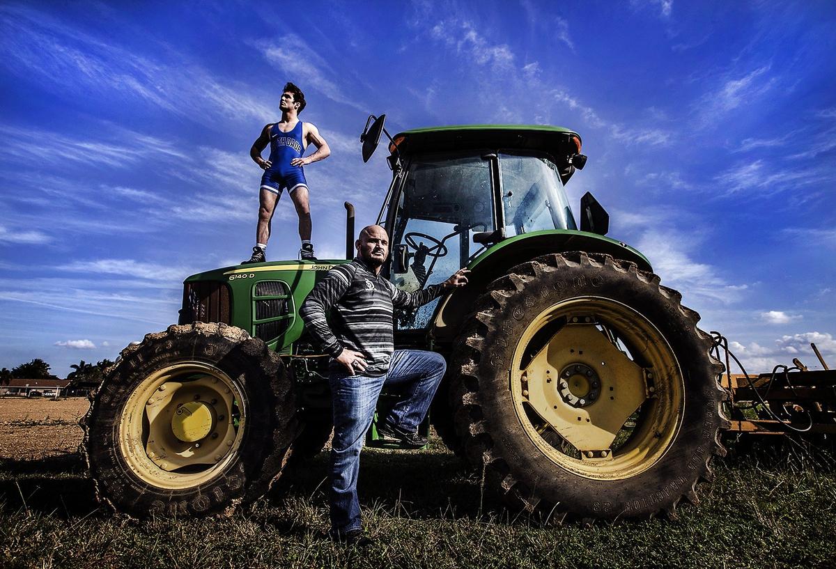 South Dade High School wrestling coach Victor Balmeceda (front) is photographed with his son Brevin, a senior at South Dade and a three-time individual state wrestling champion, on the schools agricultural grounds on Monday, February 4, 2019.