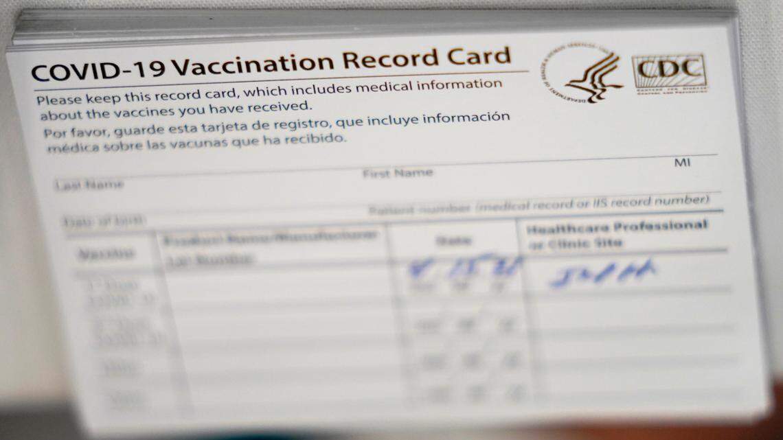 In this photo, CDC COVID-19 vaccination cards are shown at the Christine E. Lynn Rehabilitation Center at Jackson Memorial hospital,  April 15, 2021, in Miami. A woman was charged after being accused of selling fake COVID vaccine cards through Facebook and to a New York state trooper, officials say. 
