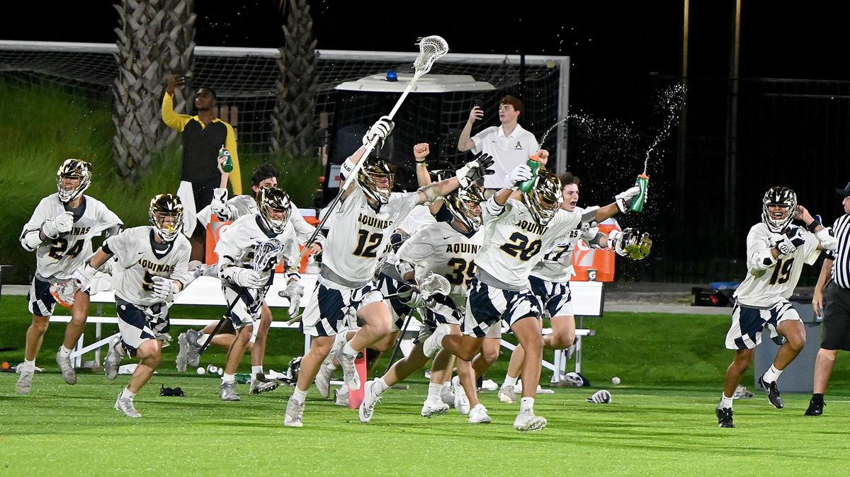 Aquinas players storm the field after beating Ponte Vedra in a Boys 2A Lacrosse State finals match up with at the Paradise Coast Sports Complex in Naples, Friday, May 7, 2022.(Photo/Chris Tilley)