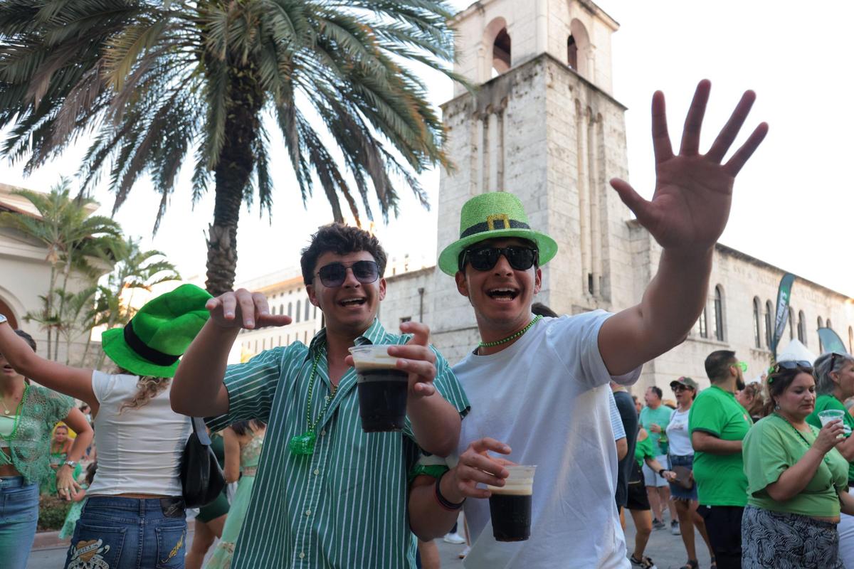 Twin brothers Julian and Adrian dance while holding a beer during the John Martin’s 32nd Annual St. Patrick’s Day Street Festival in Coral Gables, Florida, Saturday, March 15, 2025.