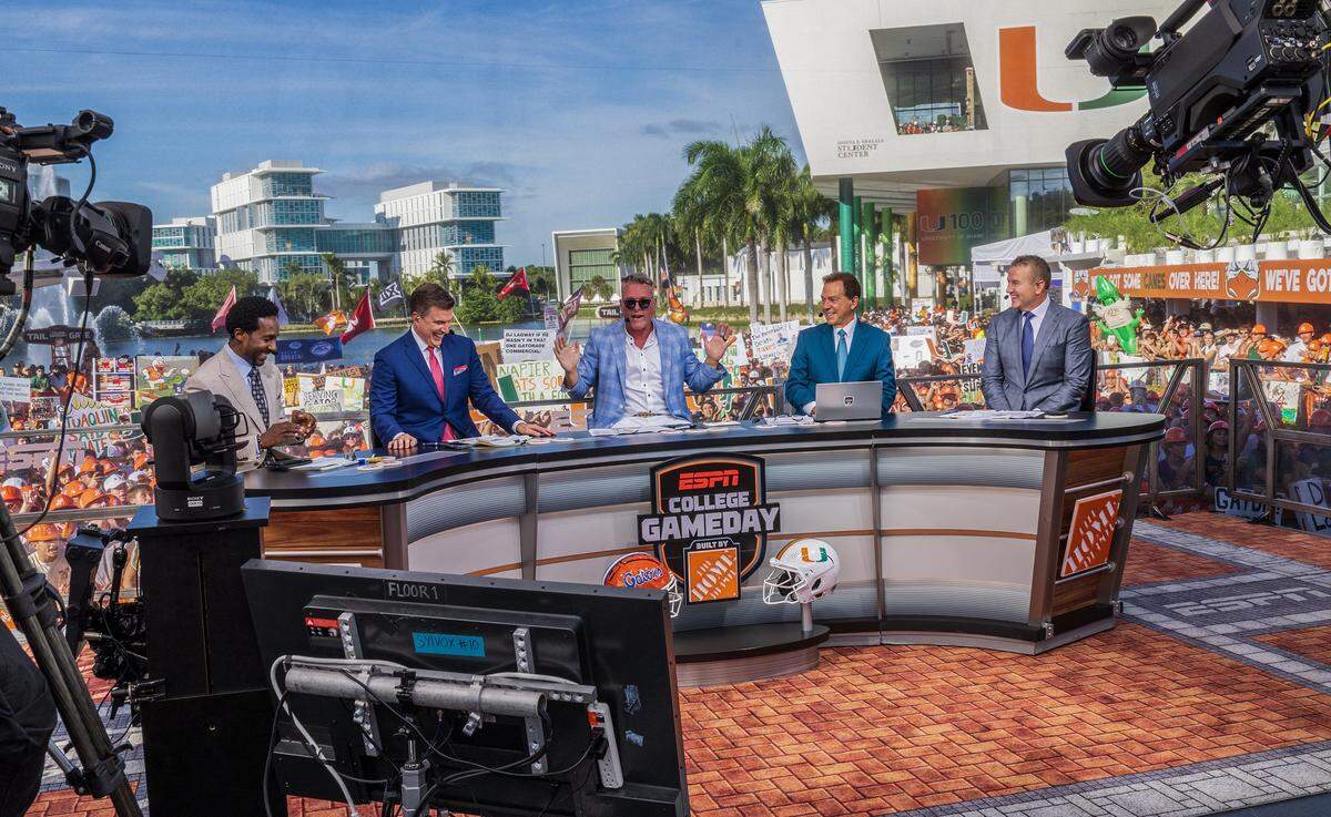 From left- ESPN hosts Desmond Howard, Rece Davis,  Pat McAfee, Nick Saban and Kirk Herbstreit seen on the set during the ESPN's College GameDay, live broadcasting from Coral Gables, where the University of Miami Hurricanes fans gathered to celebrate the Hurricanes ahead of their game against the Florida Gators, on Saturday September 20, 2025.
