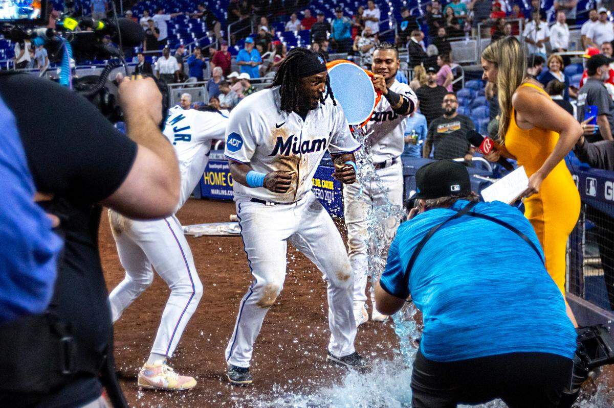 Miami Marlins first baseman Josh Bell (9) is splashed with gatorade by teammates after defeating the Philadelphia Phillies 9-8 in 12 innings of an MLB game at loanDepot park in the Little Havana neighborhood of Miami, Florida, on Wednesday, August 2, 2023.