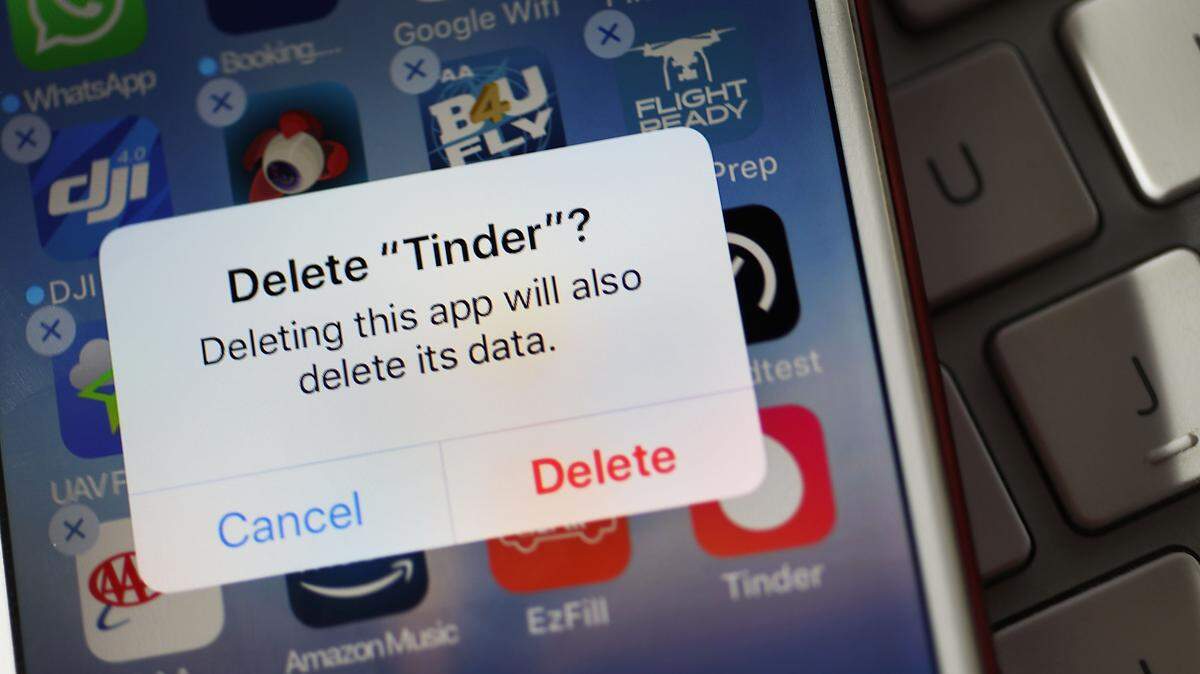 In this photo illustration, the icon for the dating app Tinder is seen on the screen of an iPhone on August 14, 2018 in Miami, Florida.