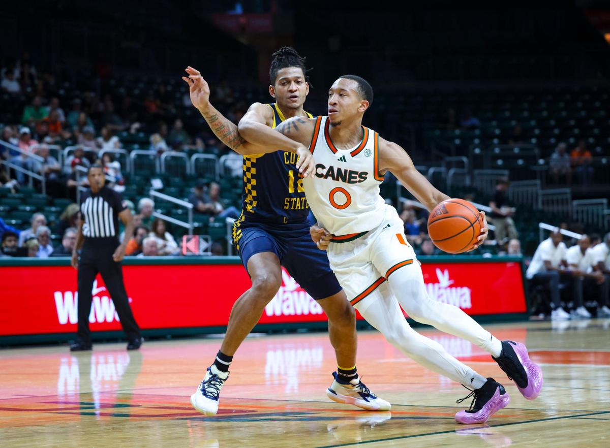 Miami Hurricanes guard Matthew Cleveland (0) dribbles passed Coppin State Eagles forward Peter Oduro (12) during the second half of a game on Sunday, Nov. 17, 2024, at the Watsco Center in Coral Gables, Fla.