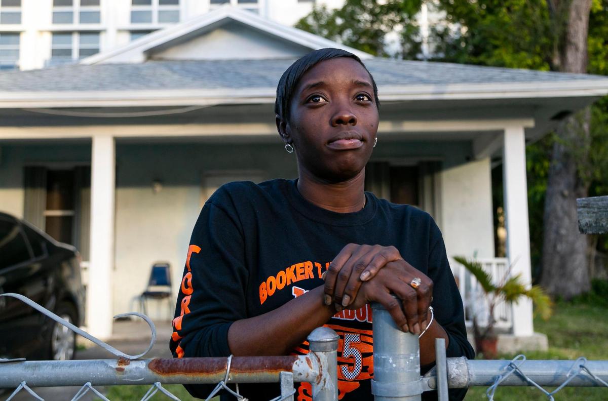 Kenisha Ford, 29, stands at the front gate of her home, built by Habitat for Humanity of Greater Miami, in the Highland Park neighborhood. Ford is worried about the impact of rezoning and redevelopment around her home, where she has lived since 1997.