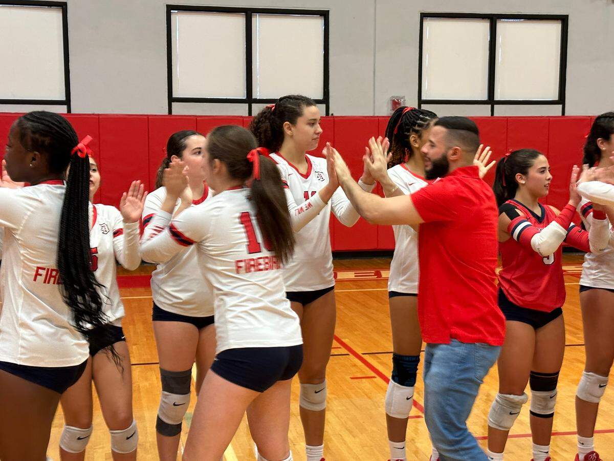Doral Academy girls’ volleyball players congratulate each other after beating Weston Cypress Bay in a Region 4-7A semifinal on Saturday at the Firebirds’ gym.