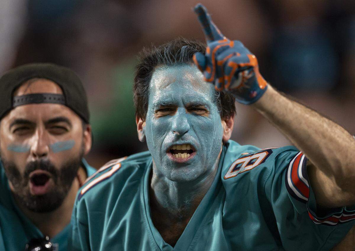 Miami Dolphins fans cheer for their team as they play against the New York Jets in the first half of their NFL game at Hard Rock Stadium on Monday, Sept. 29, 2025, in Miami Gardens, Fla.